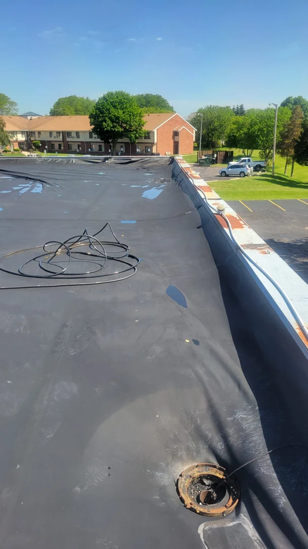 commercial flat EPDM rubber roof with minor wear and ponding water