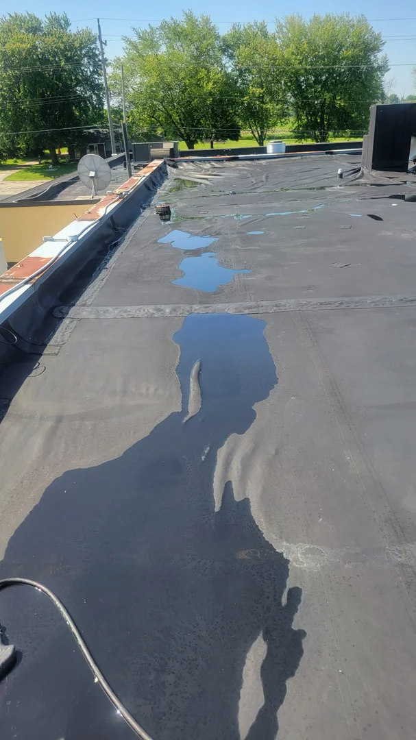 emergency roof tarping commercial flat roof pooling water storm damage